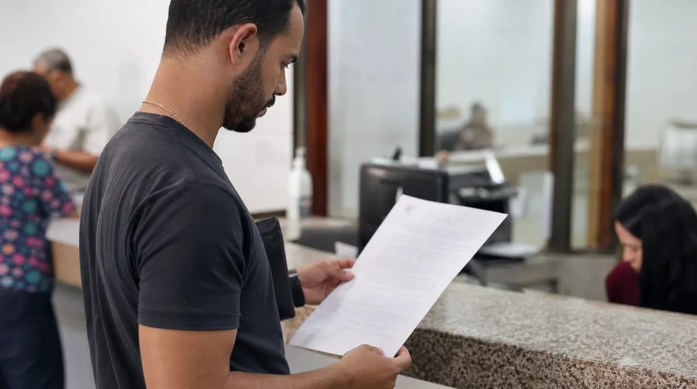 A person reviewing a lien certificate at the Public Registry Office of a Venezuelan municipality